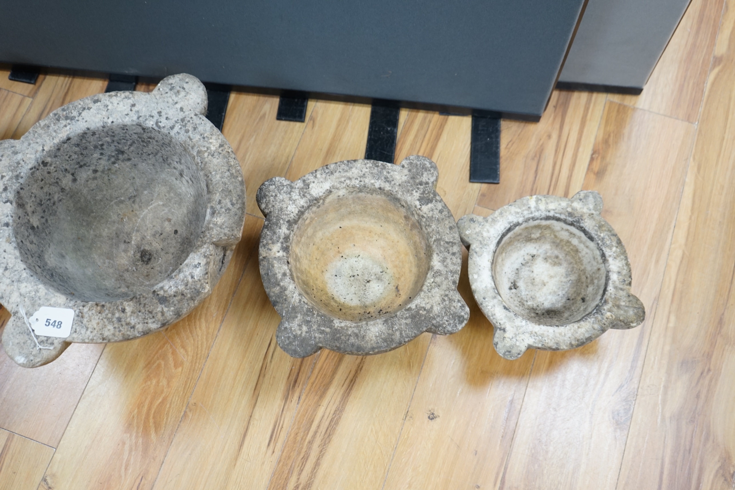 Four graduated marble mortars, largest 46.5cm wide across top rim. Condition - largest mortar has a handle missing, all have been stored outside and are marked